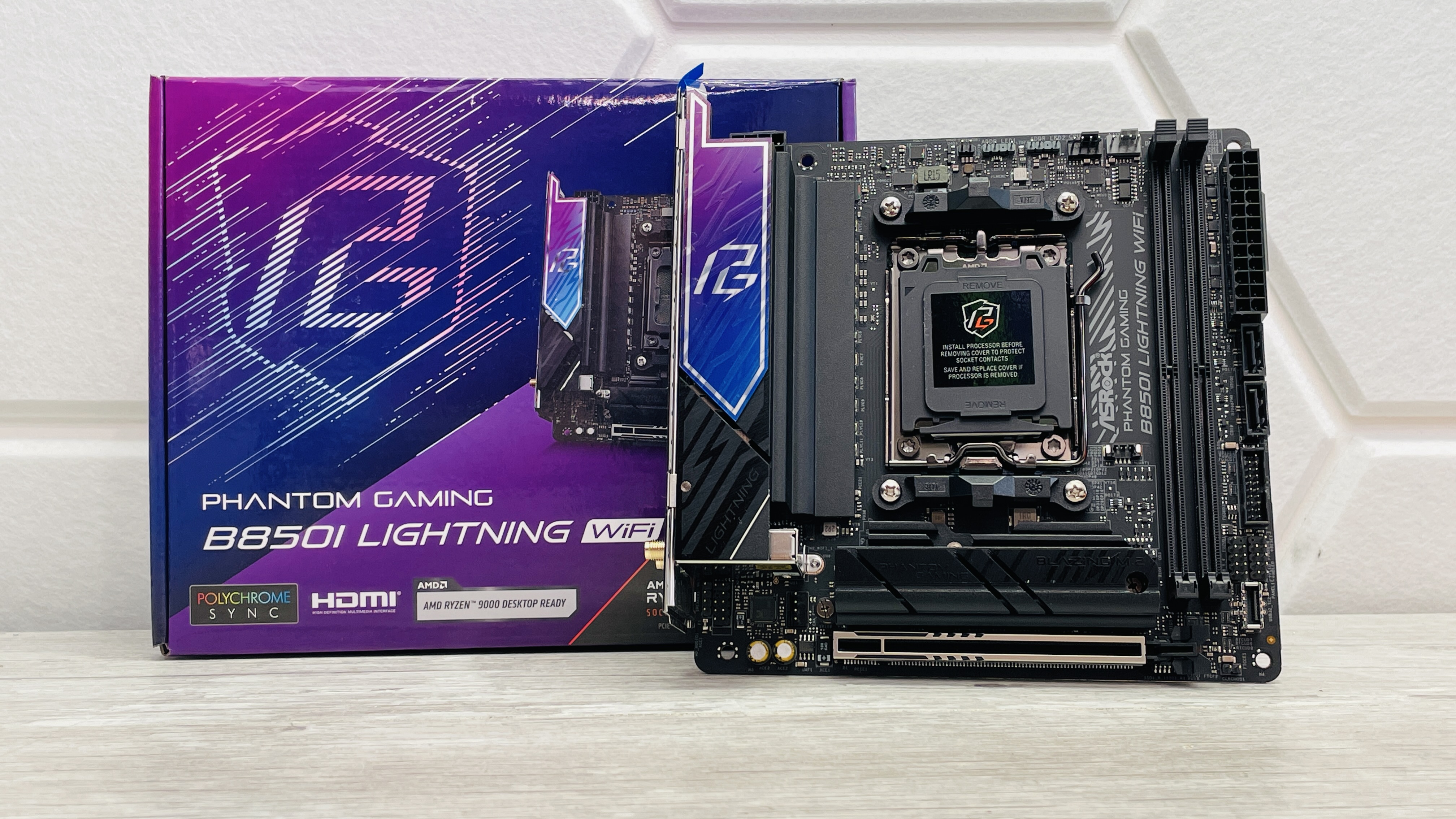 ASRock Phantom Gaming B850I Lightning Wi-Fi motherboard on a desk.